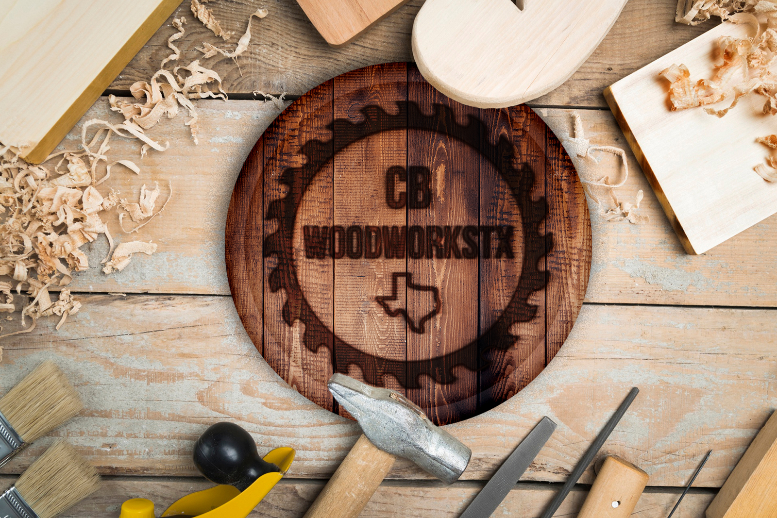 Woodworking tools around a round wooden sign engraved with CB Woodworks TX and Texas outline.