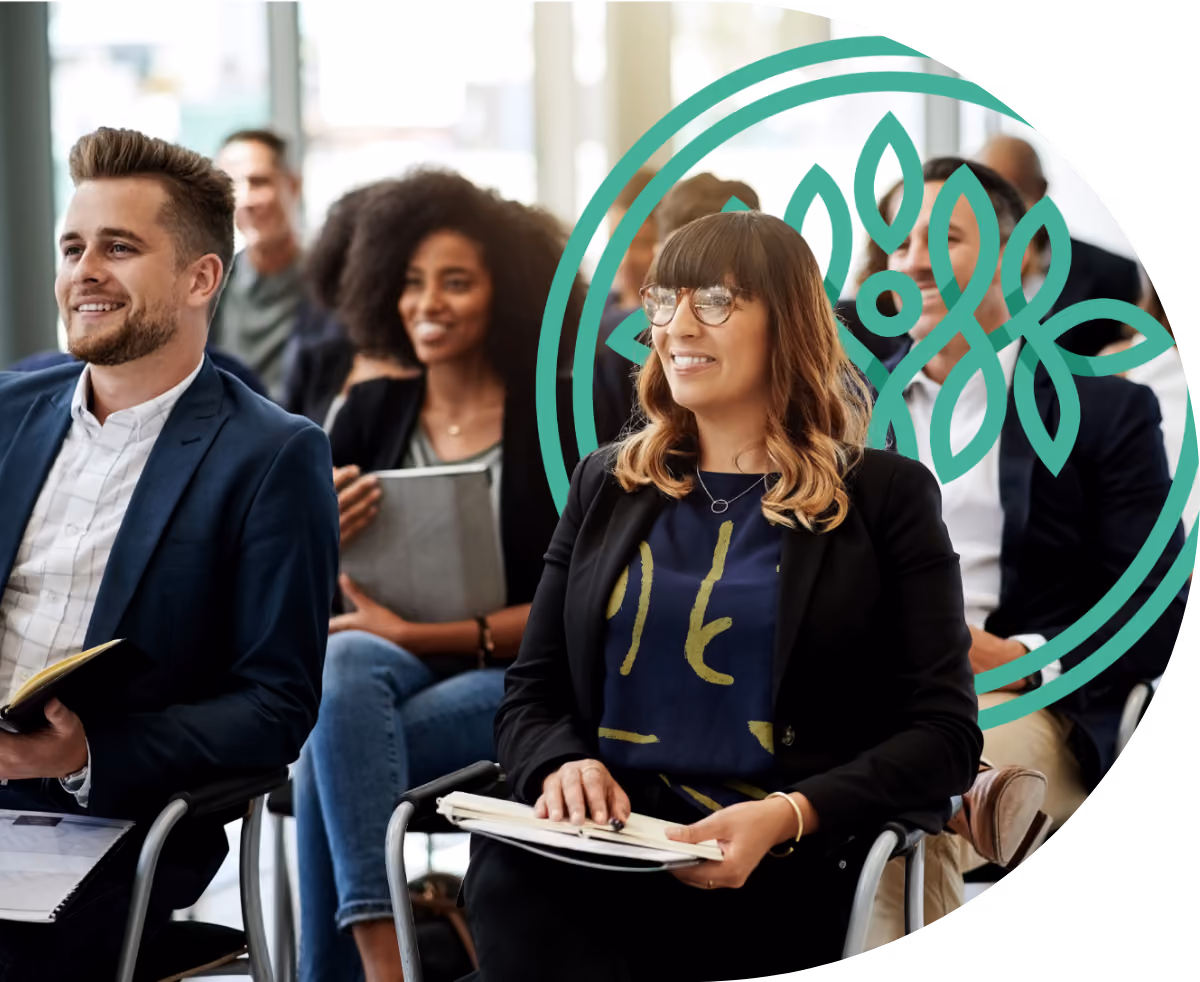 Professionals intently listening at a conference, taking notes on notepads
