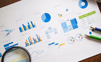 Pricing analytics charts and market data on a desk