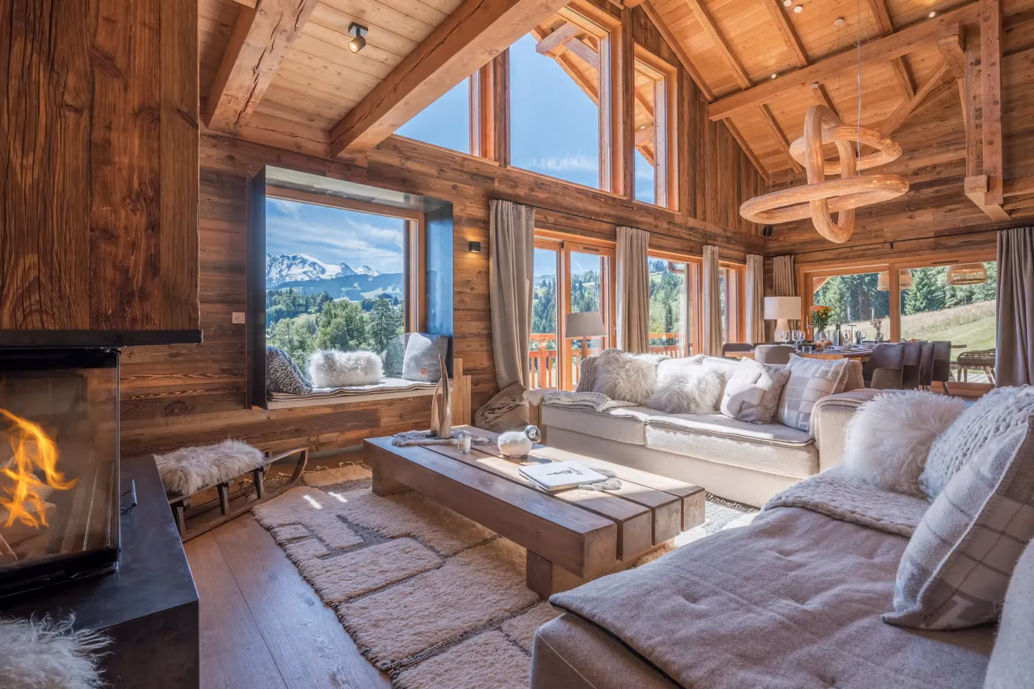 Luxury chalet living room with fireplace, vaulted ceiling and Mont Blanc views in Megève.