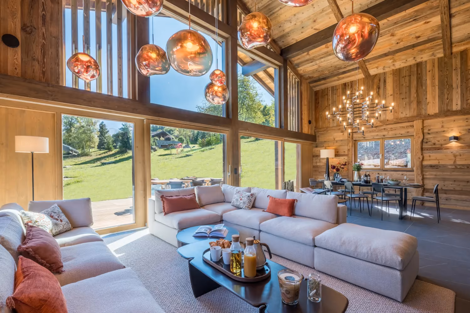 Bright living room with large picture windows in a luxury chalet in Combloux.