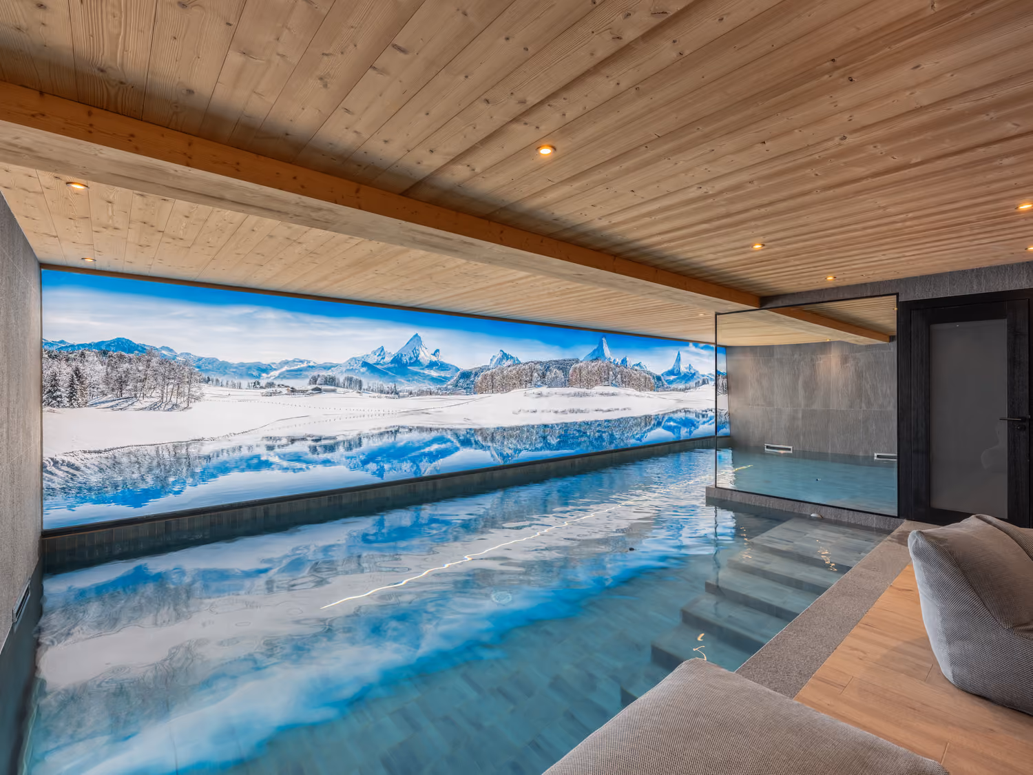 Heated indoor swimming pool with relaxation area in a luxury chalet overlooking Mont Blanc