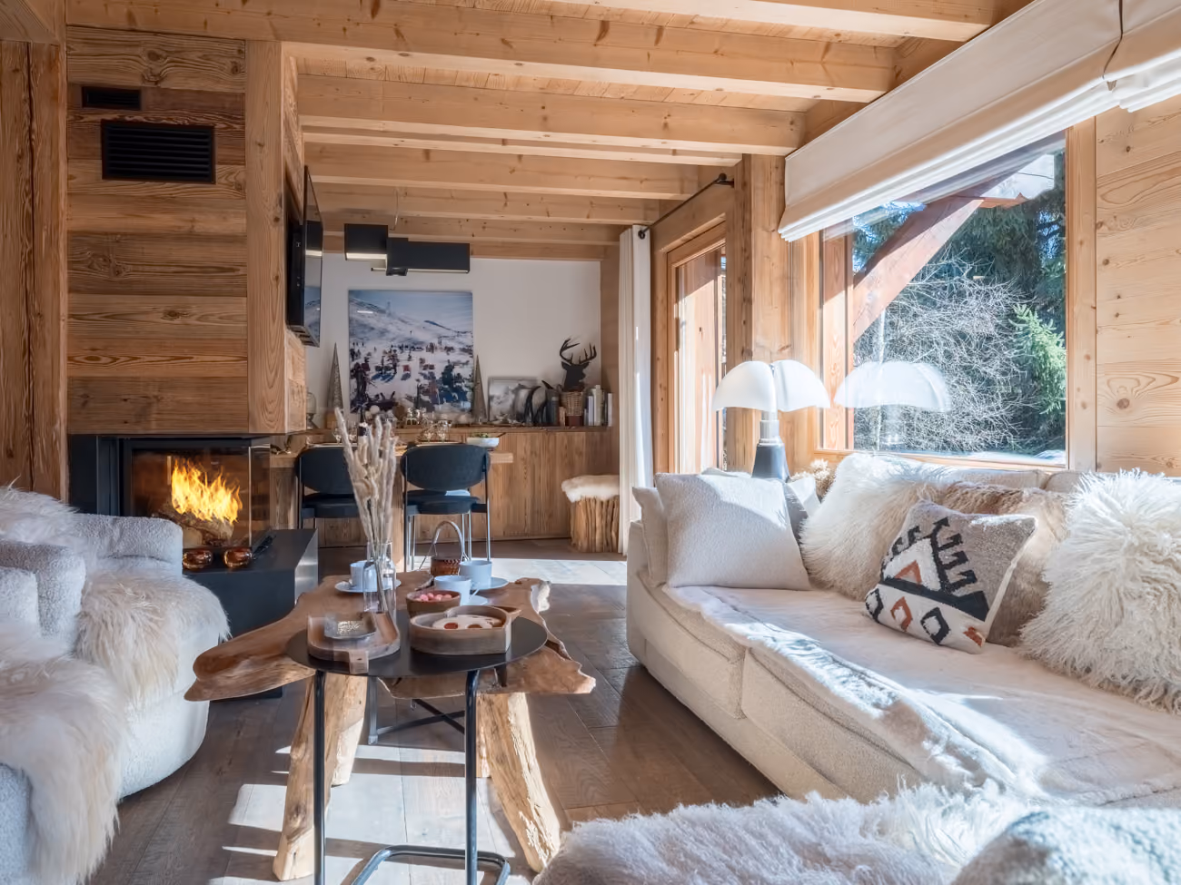 Bright living room with contemporary fireplace and comfortable lounge area in a luxury chalet