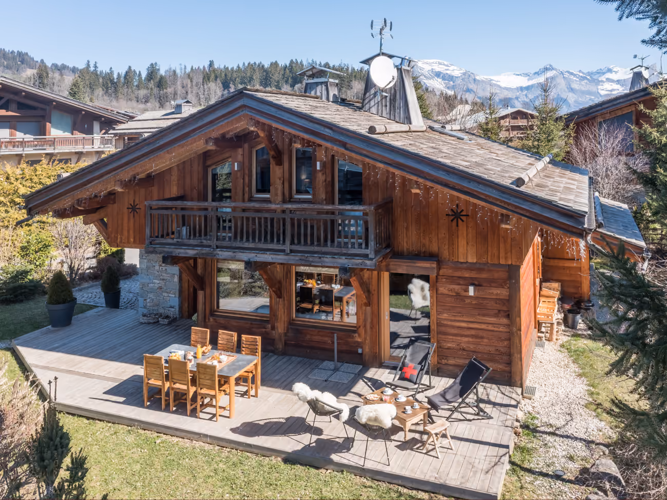 Exterior view of the chalet with spacious wooden terrace and private garden