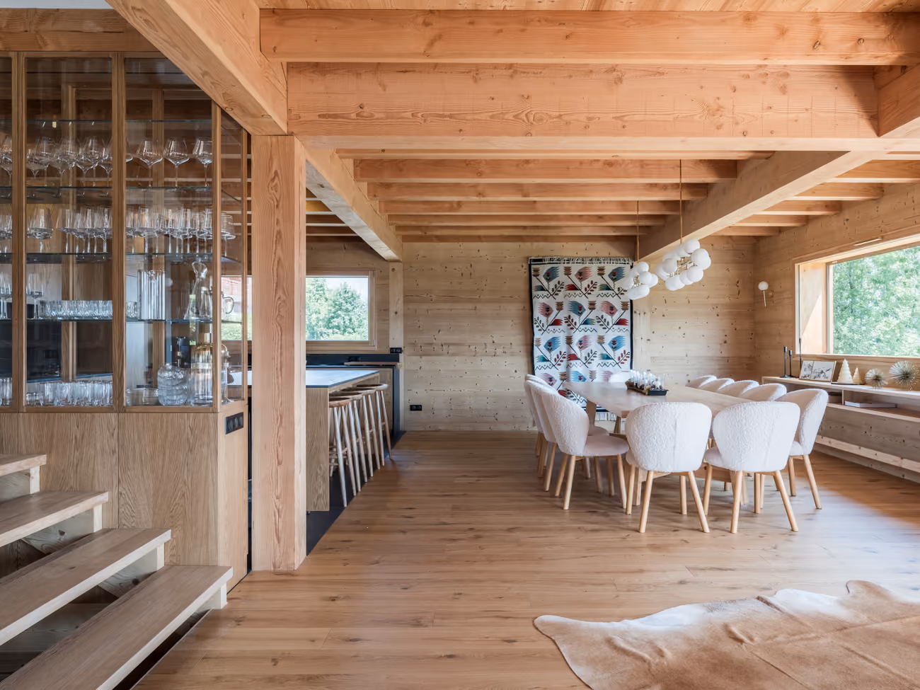 Open dining area and kitchen in a luxury chalet with mountain views
