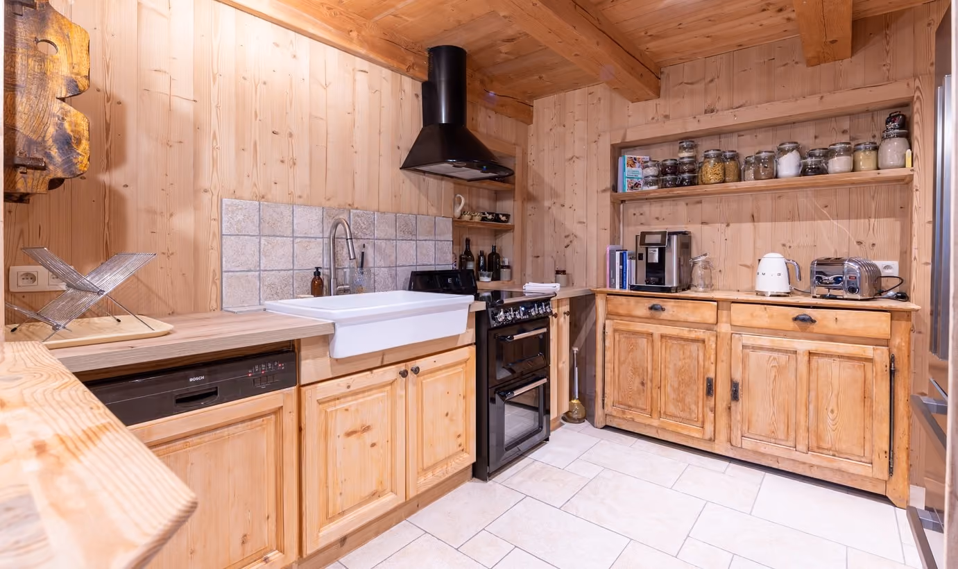 Cuisine équipée alliant charme traditionnel et équipements modernes dans un chalet à Megève.