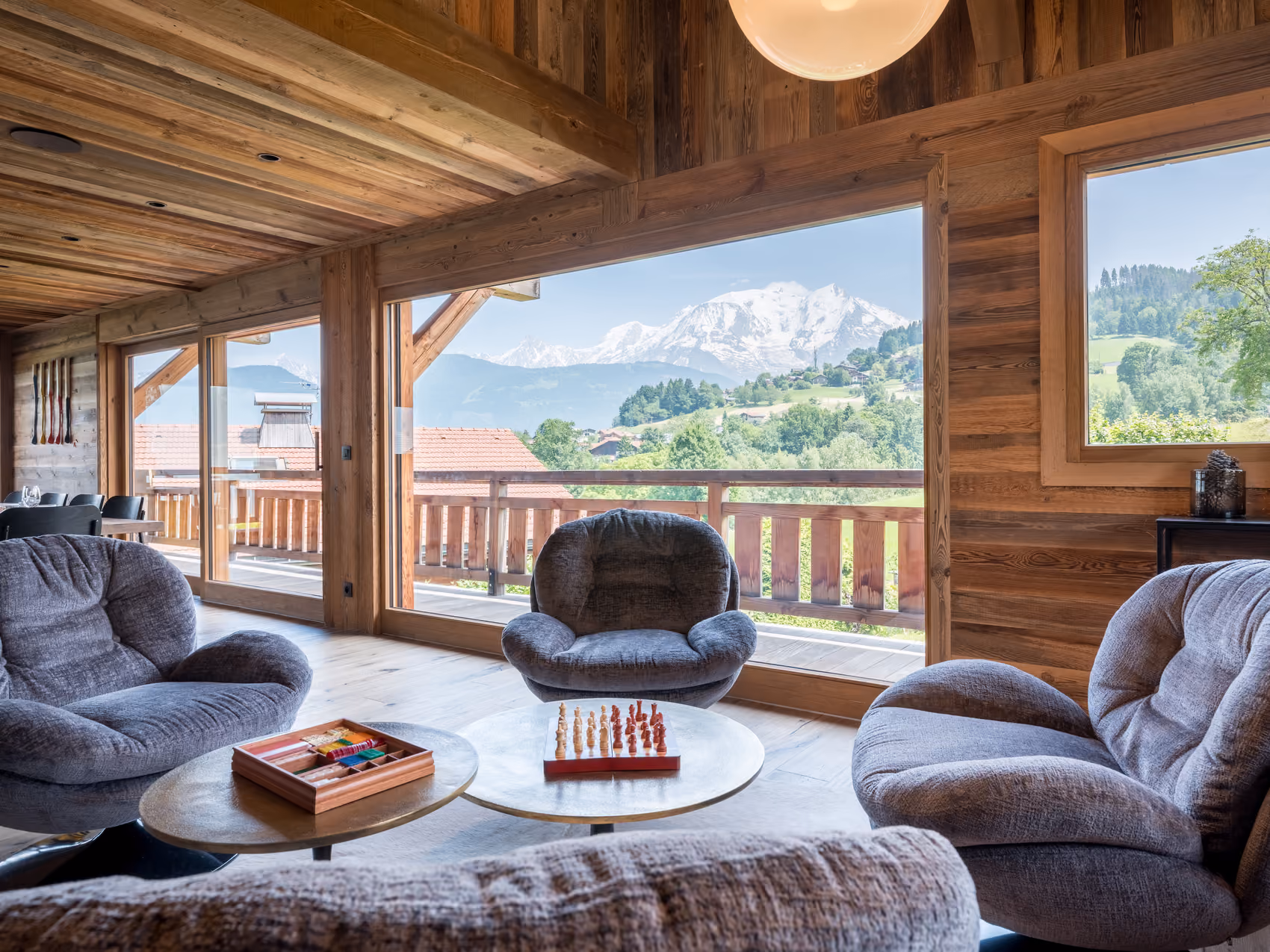 Lounge area with panoramic Mont Blanc views through floor-to-ceiling windows at Chalet Double M.