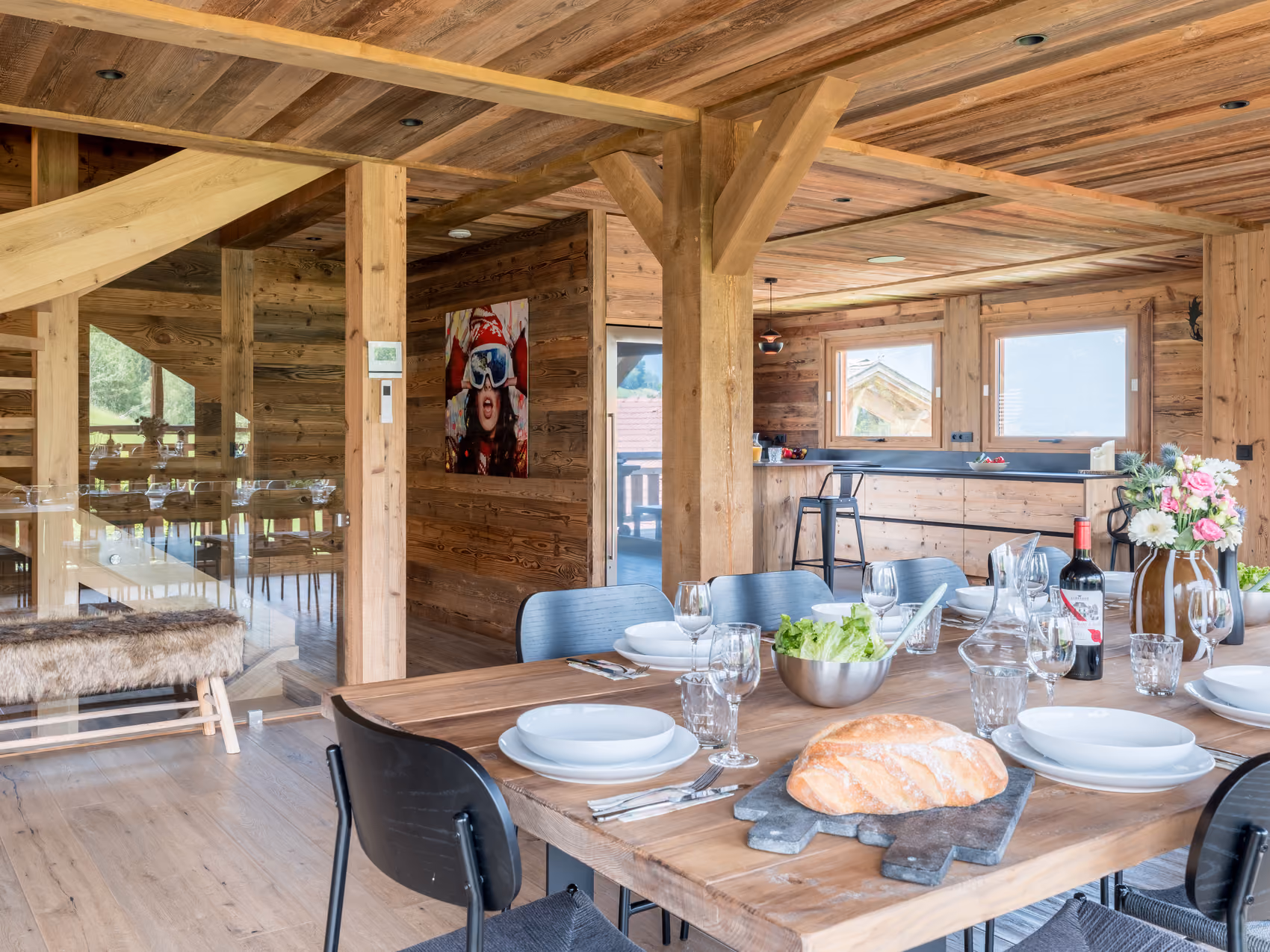 Open-plan dining area and rustic wood kitchen in a luxury chalet in Combloux.