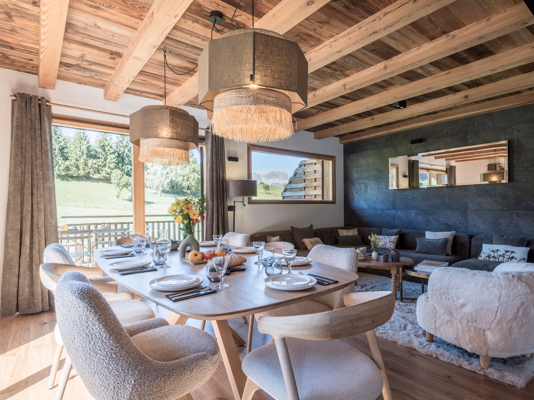 Cosy living room and open dining area with terrace access at Chalet Zazen in Combloux.