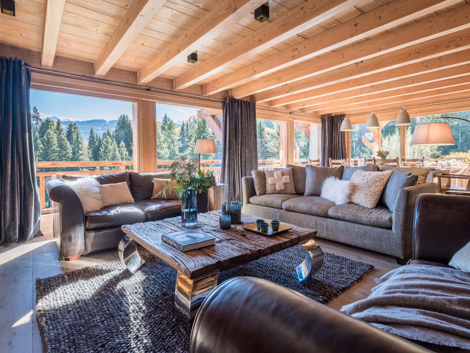 Bright open-plan living space with lounge, dining area and panoramic mountain views in Combloux.