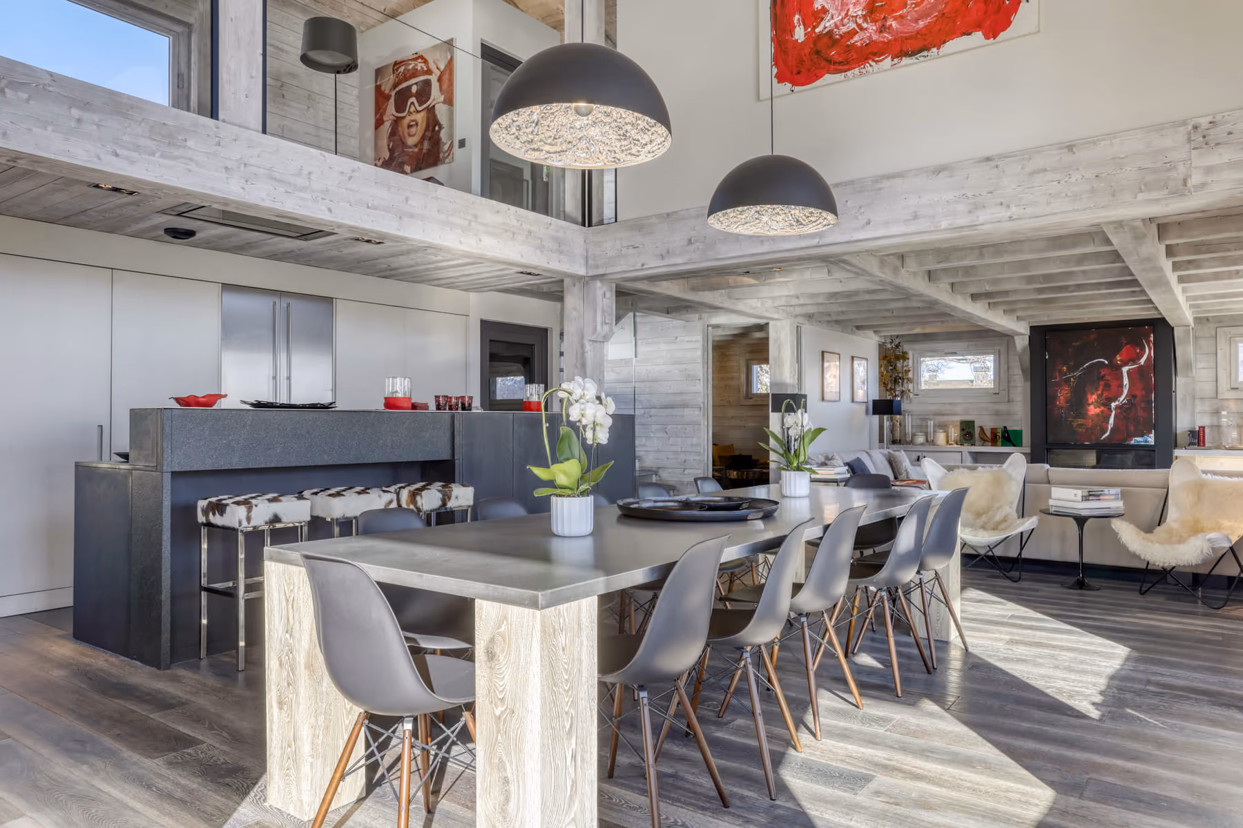 Open-plan dining area with contemporary kitchen and bright living spaces in a luxury mountain chalet.
