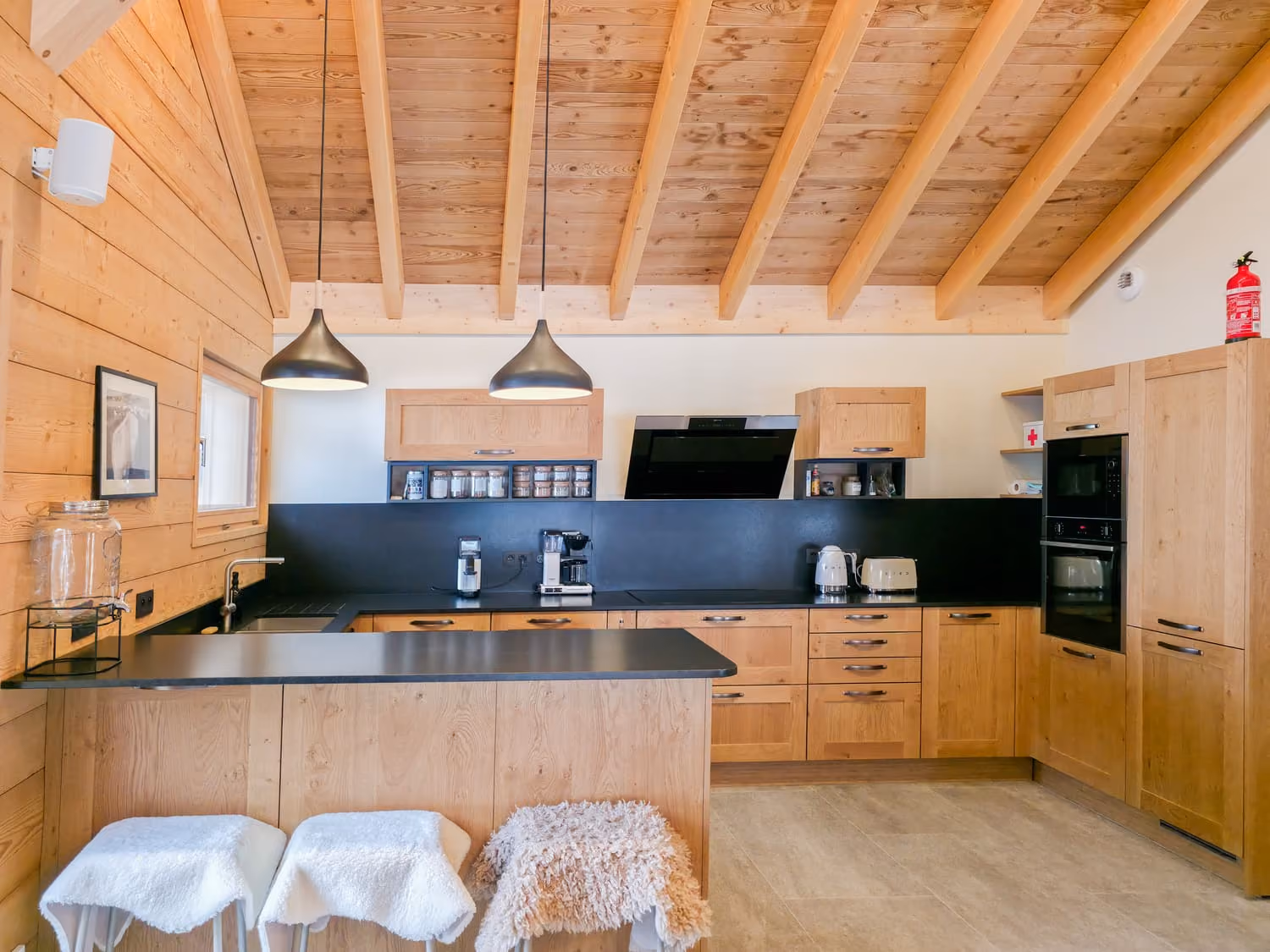 Fully equipped kitchen with central island opening onto the chalet's living areas.
