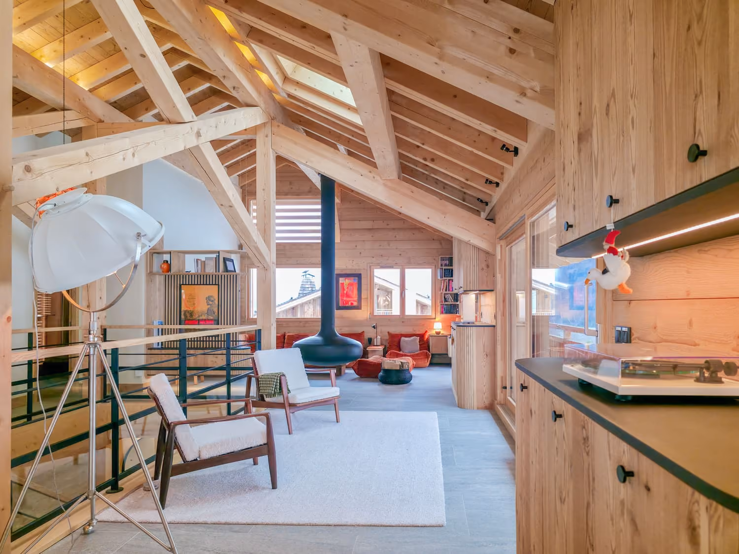 Bright living space with suspended fireplace, lounge area and contemporary timber architecture.
