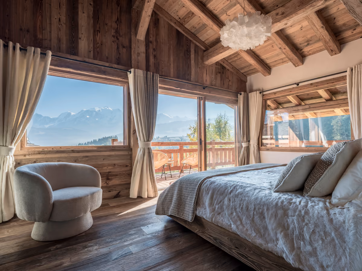 Elegant bedroom with a private balcony and Mont Blanc views at Chalet Marianna in Combloux.