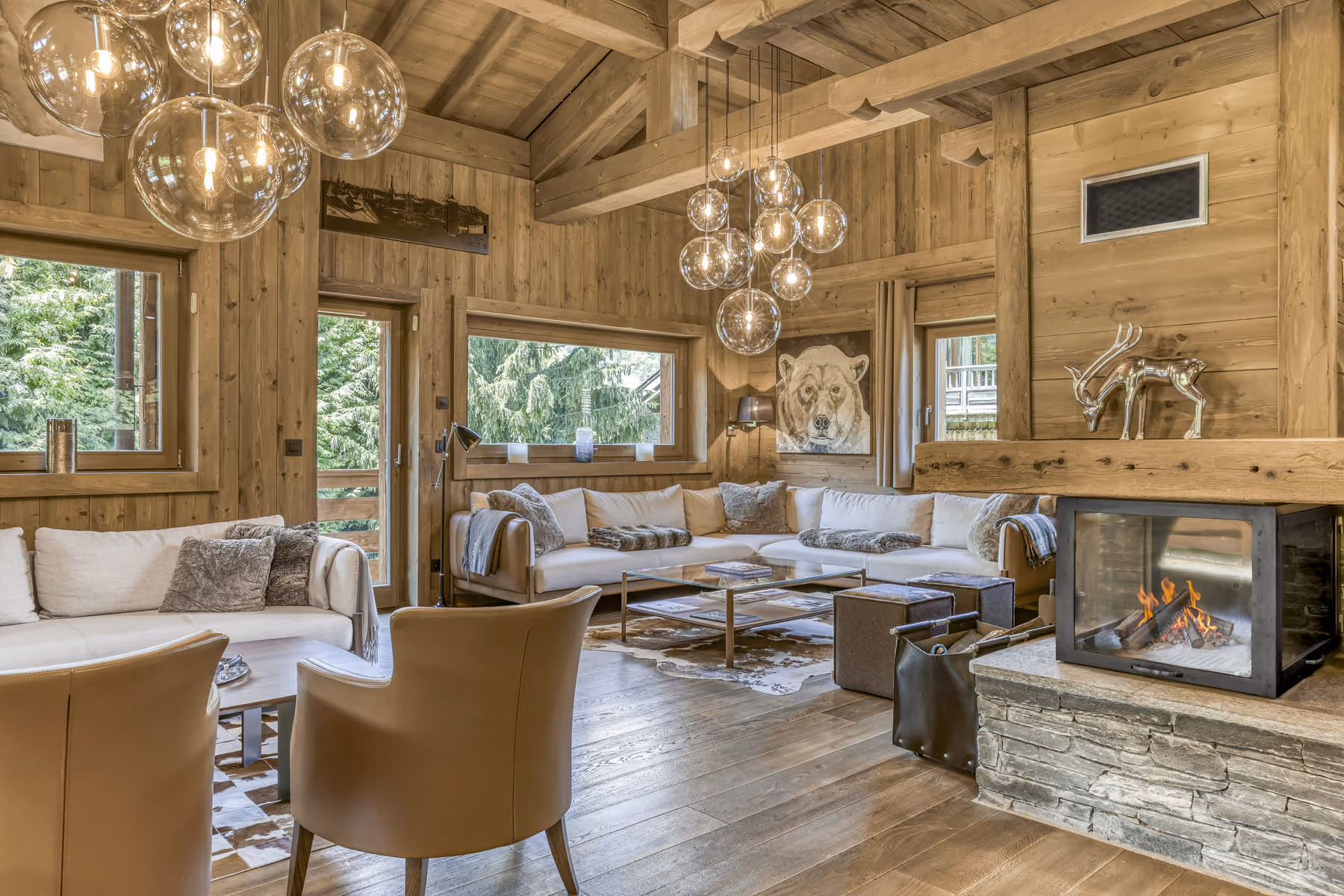 Living room with fireplace and vaulted ceiling at Chalet des Ours, luxury chalet in Megève.