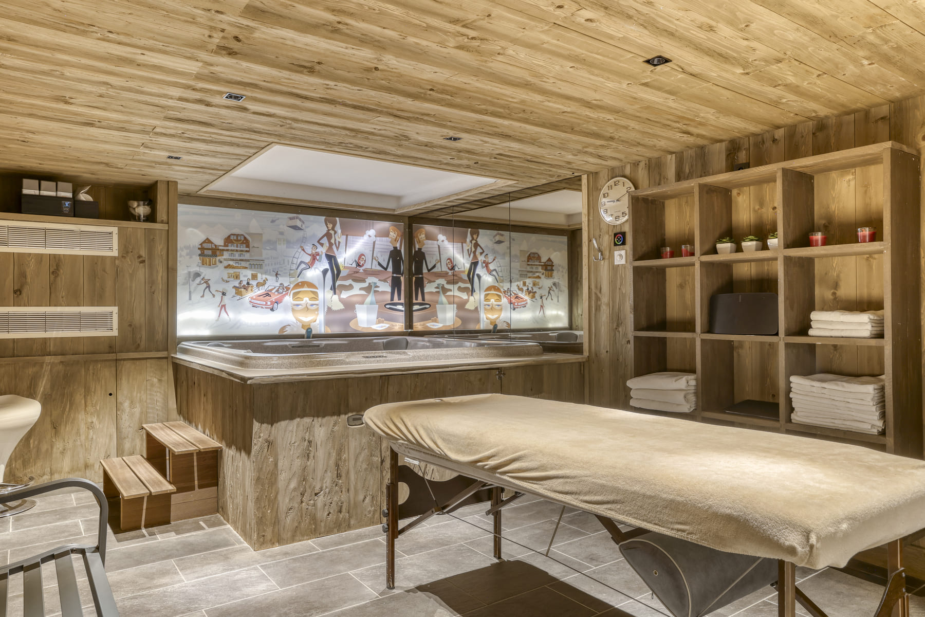 Espace bien-être avec jacuzzi et table de massage au Chalet des Ours, chalet avec spa à Megève.