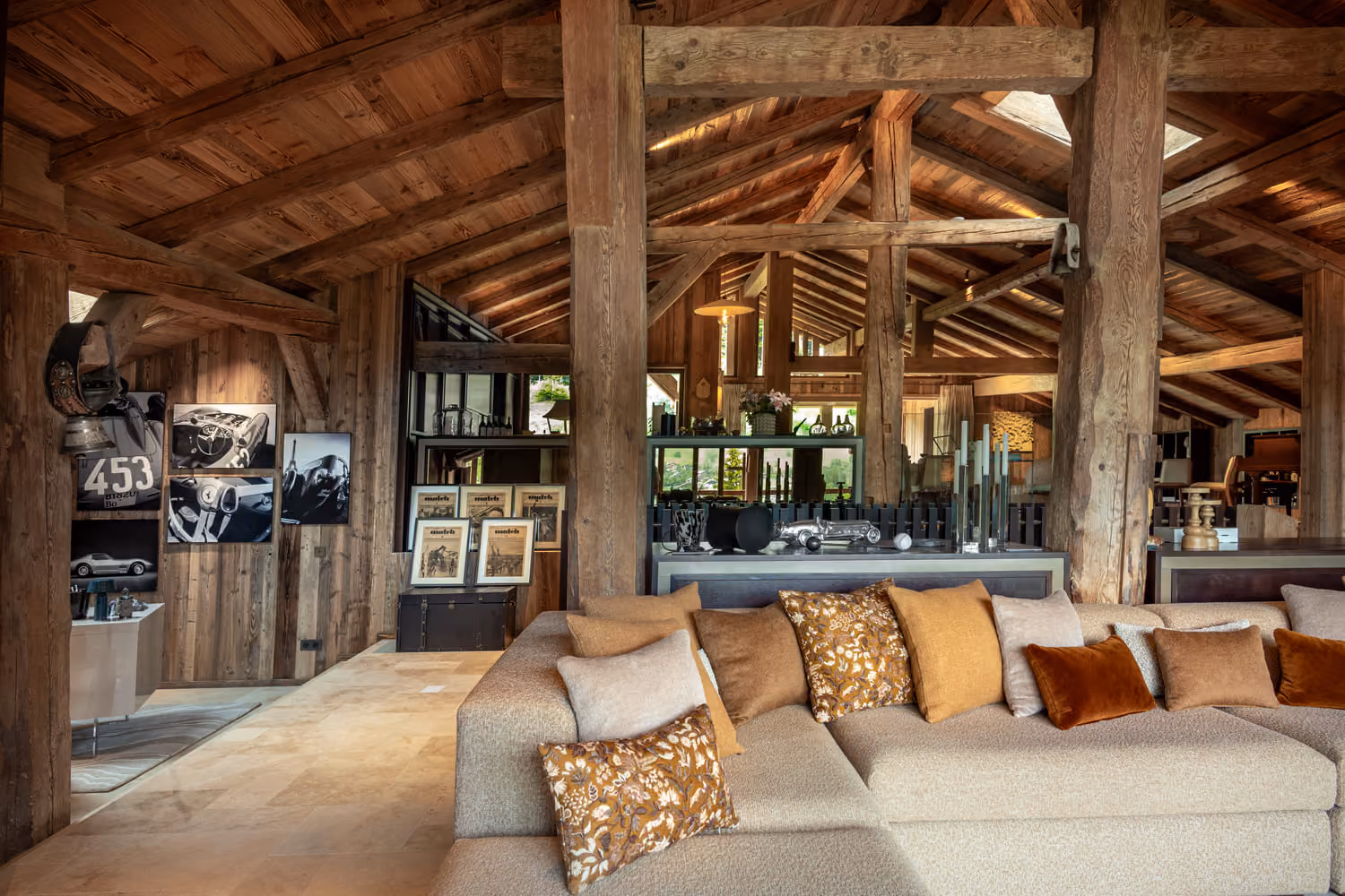 Living room beneath exposed timber beams in a luxury chalet for rent in Megève.