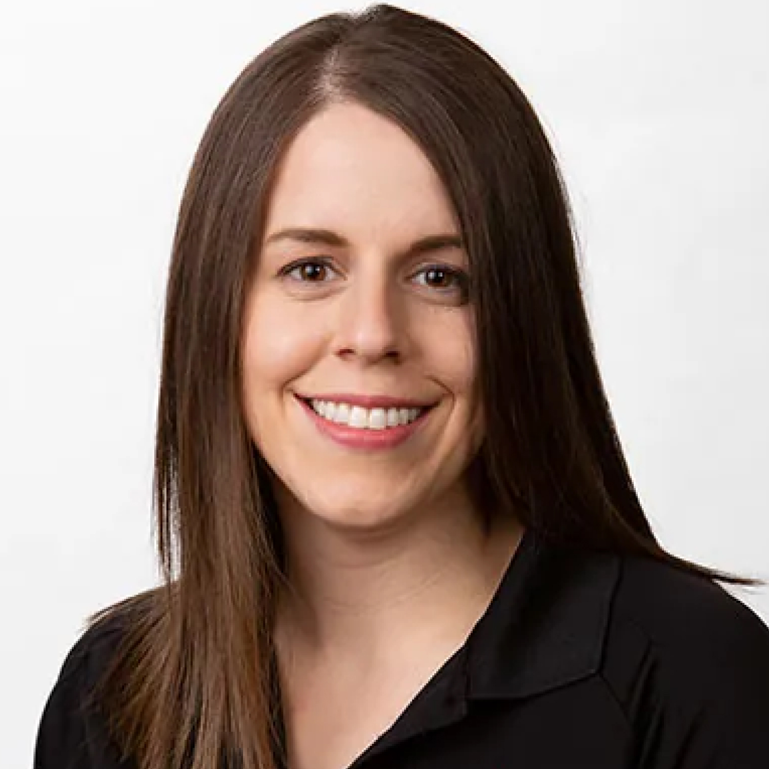 Headshot of Andrea Rhodes, OTD, smiling and wearing a black collared shirt against a light background.