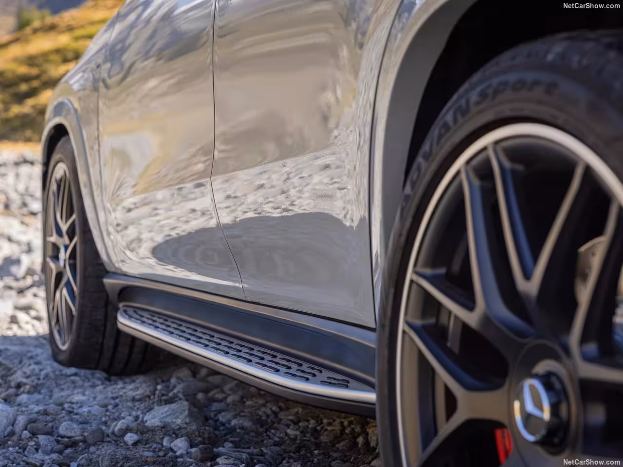 Mercedes GLE 53 AMG driving on Swiss roads, luxury SUV rental for weekend trips