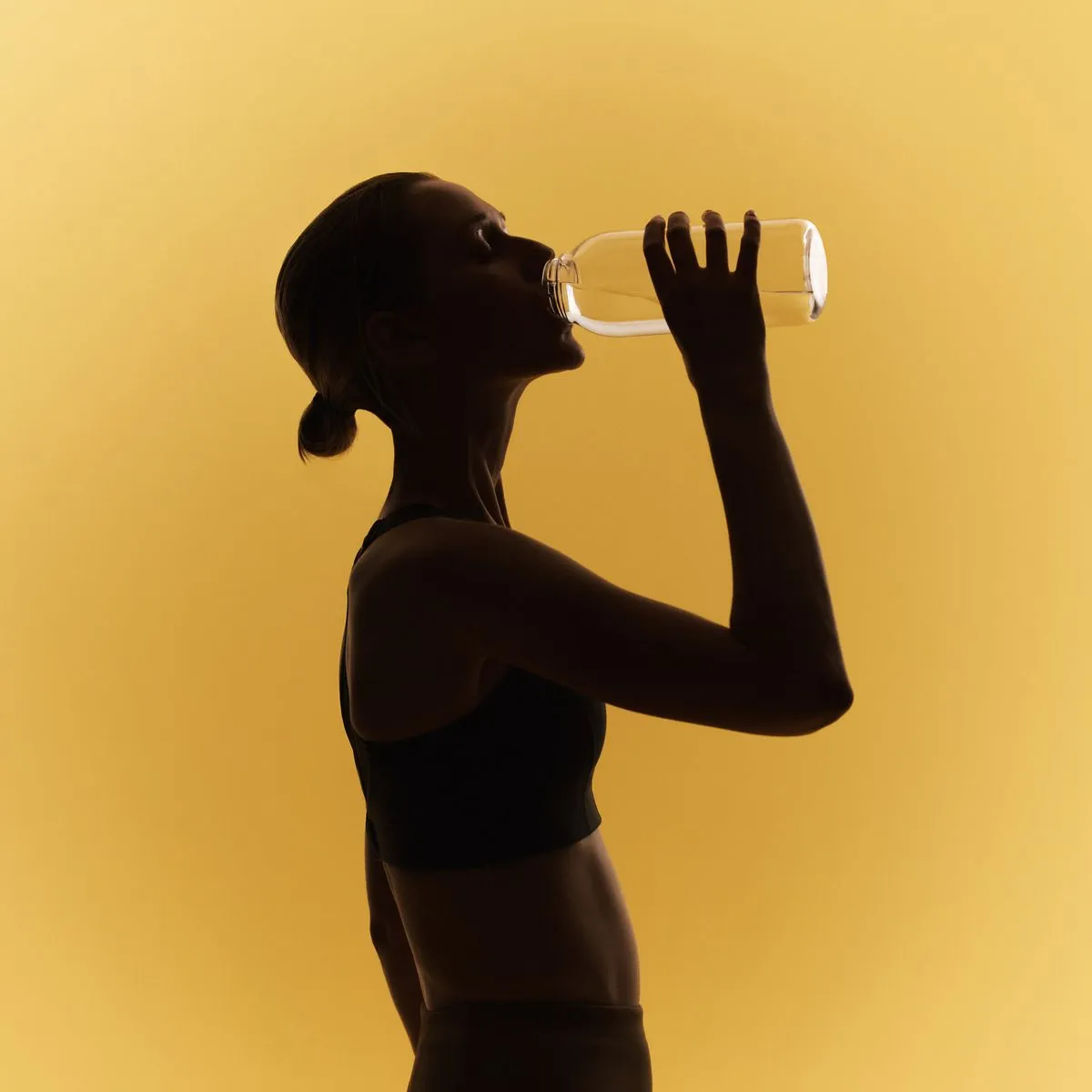 Silhouette of woman drinking water