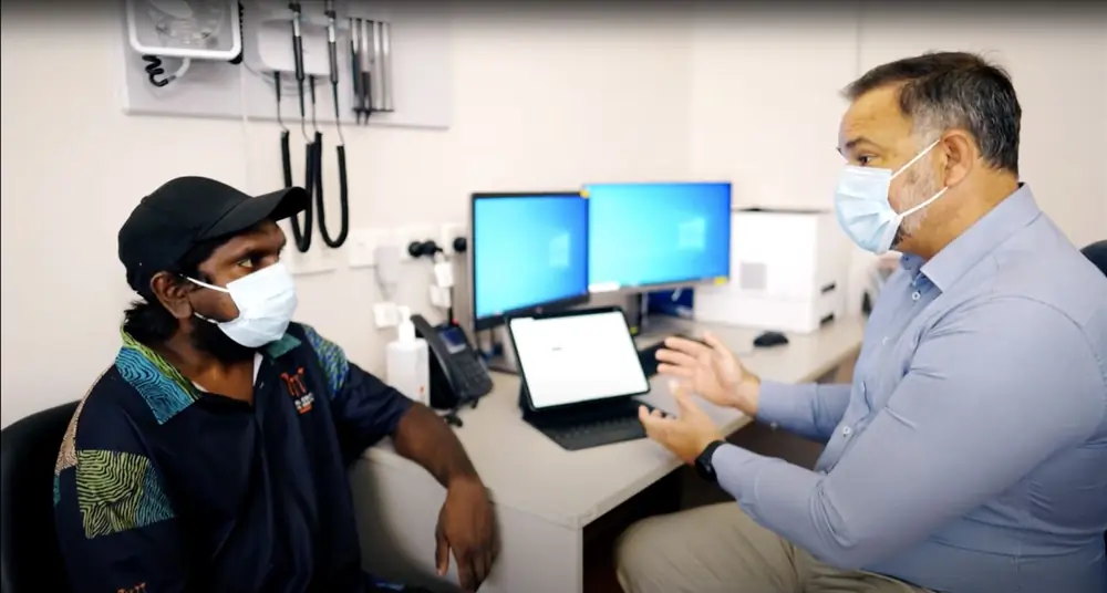 A clinician talking with a patient during a consult