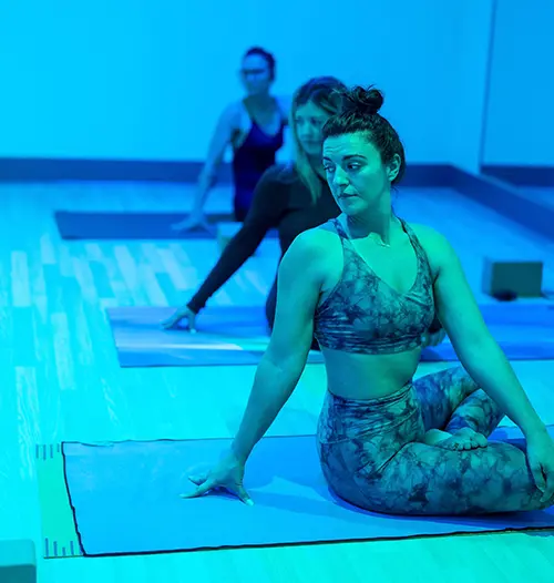 A girl attending a hot yoga experience
