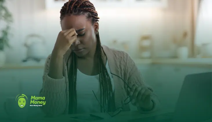 Woman looking stressed while managing finances, representing the effects of inflation on remittances.