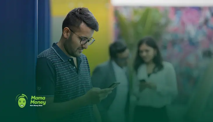 Man checking his smartphone while using a digital money transfer service