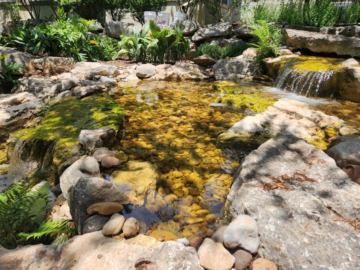 natural stream and waterfall feature in Texas Hill Country landscape