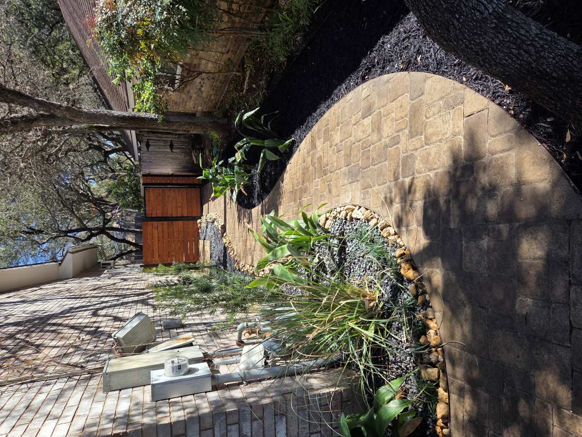curved paver walkway through landscaped garden in San Antonio