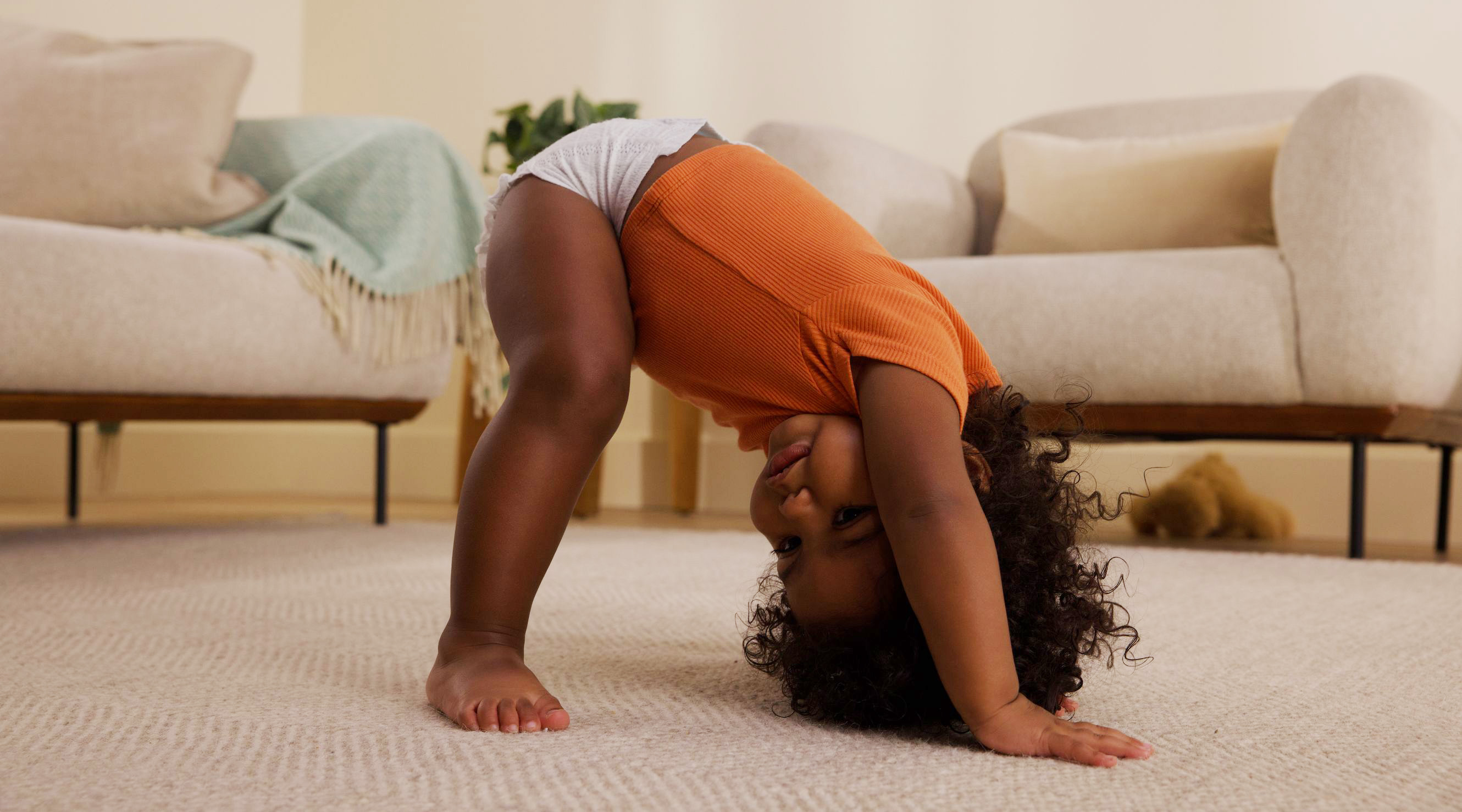 Baby looking to side on hands and feet