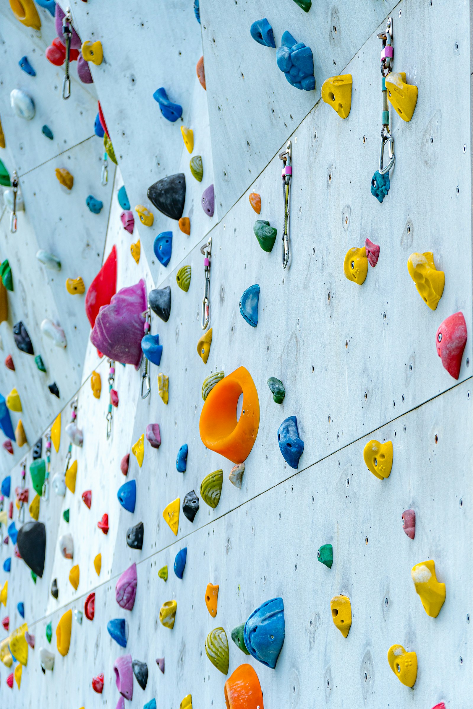 A climbing wall with colorful climbing holds
