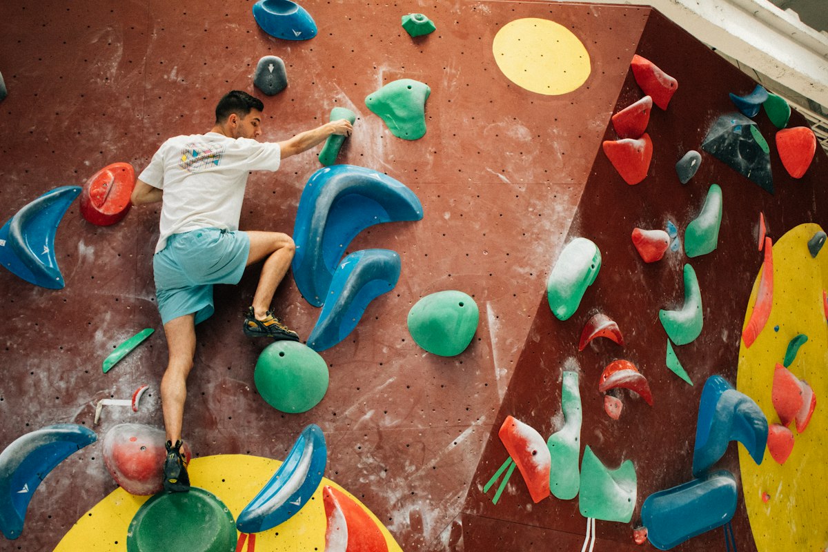 A climber training on an indoor climbing wall