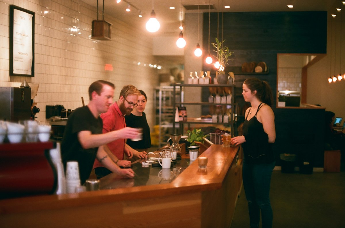 People gathered together at a coffee shop counter