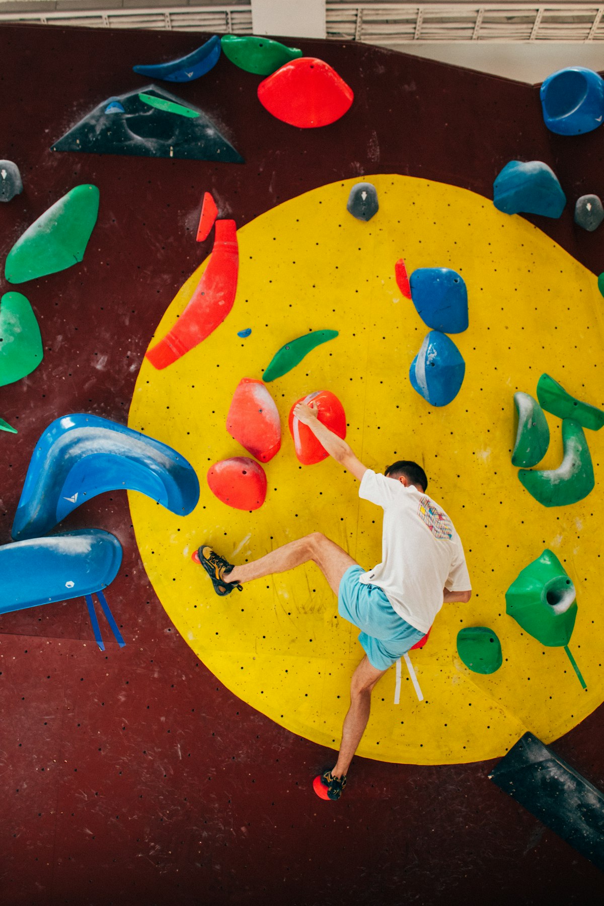 A climber on an indoor climbing wall