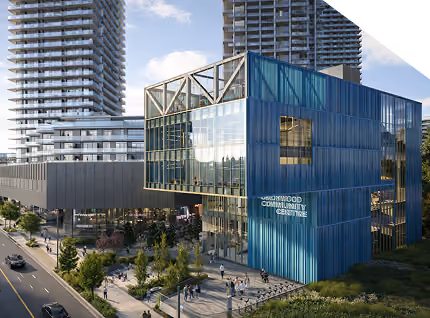 Modern blue Greenwood Community Centre building with glass windows and nearby high-rise towers.