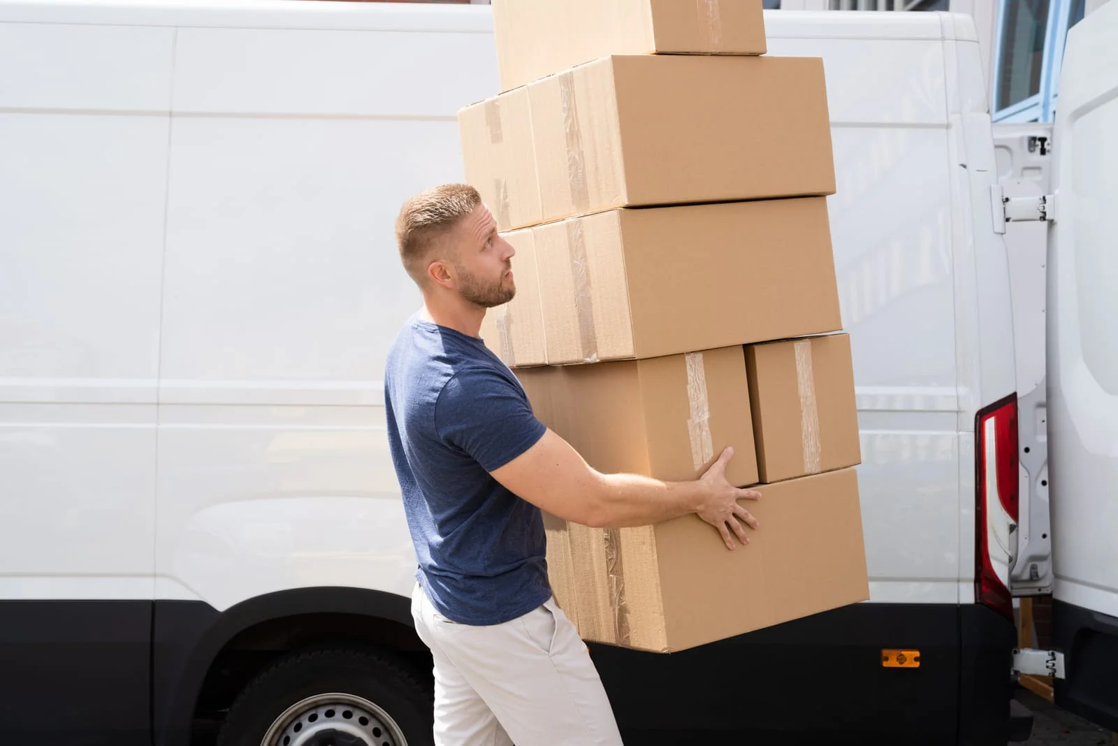 man carries boxes