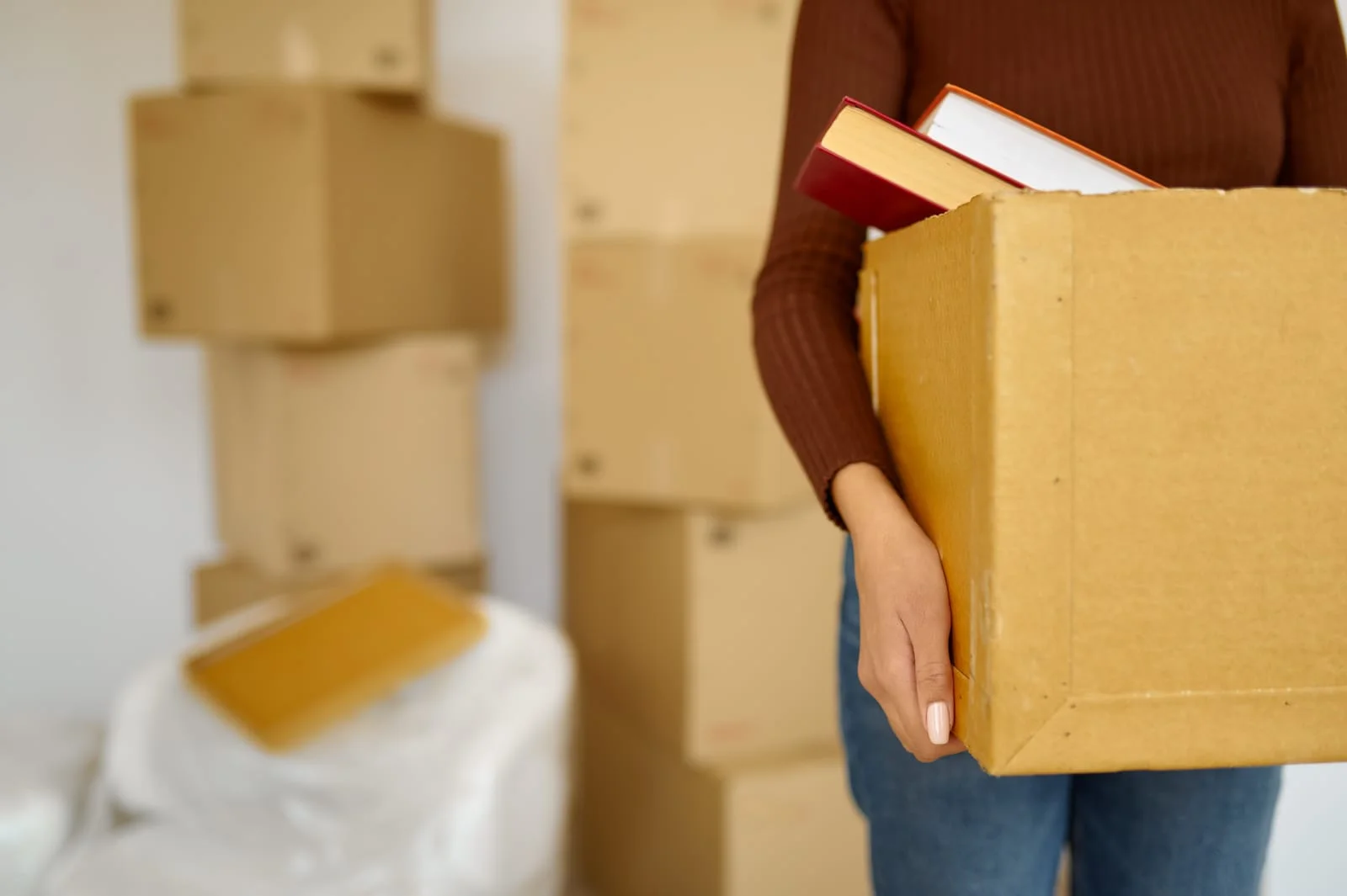 girl holding moving box