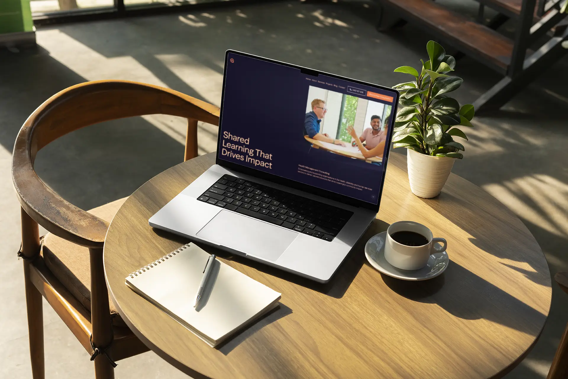 HealthQ Consulting Website Design by Studio Sondar displayed on a macbook on a coffee table.