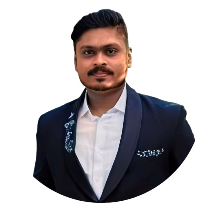 Portrait of a man with neatly styled hair and a trimmed beard wearing a dark suit with decorative embellishments and a white shirt.