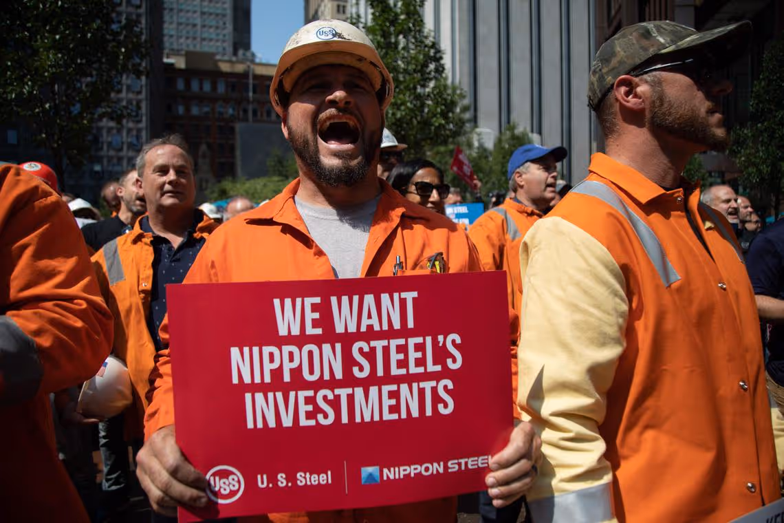 US Steel Corporation workers rally outside the company's headquarters in Pittsburgh, Pennsylvania, supporting the takeover by Japan's Nippon Steel, on September 4, 2024. United States Steel warned Wednesday it could shut its Pittsburgh headquarters and shutter long-running factories in Pennsylvania if the politically sensitive takeover by Nippon is blocked. (Photo by Rebecca DROKE / AFP)