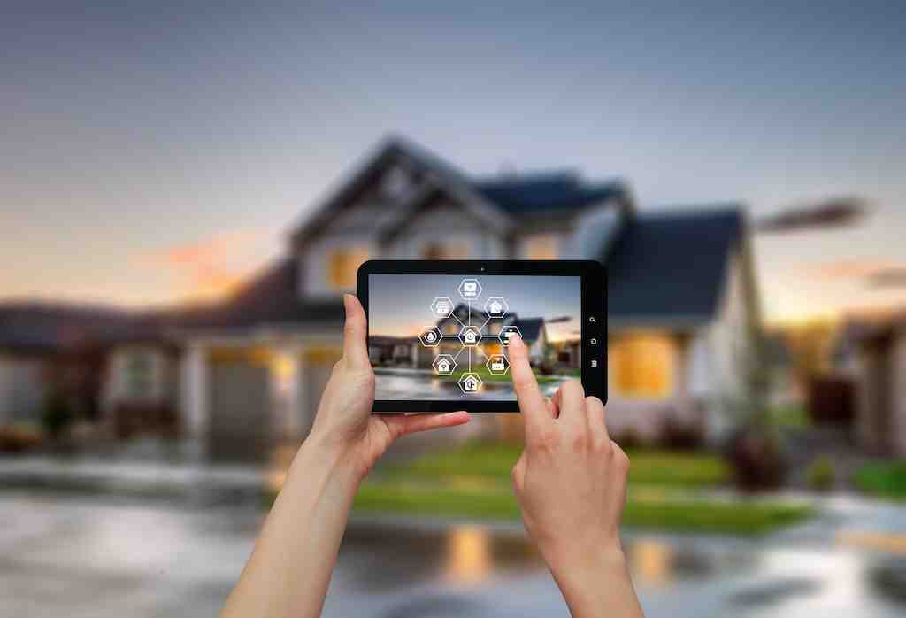 business owner using a smartphone to view CCTV footage and arm their alarm system remotely - electronic alarms and installations