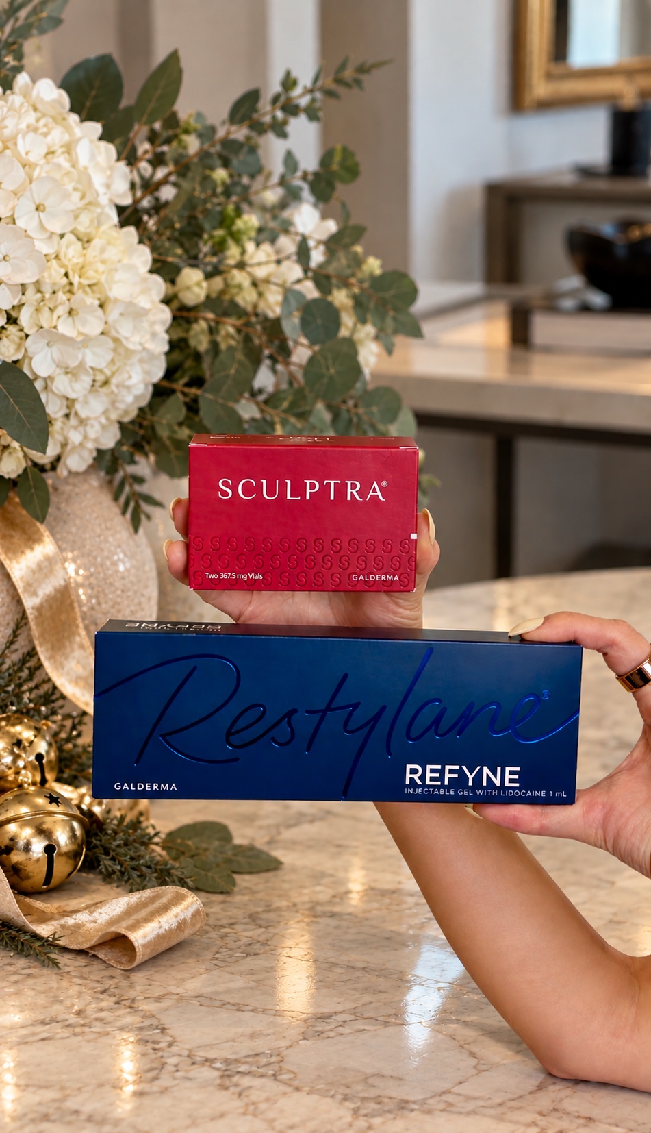 Sculptra and Restylane Refyne boxes held up beside holiday decor