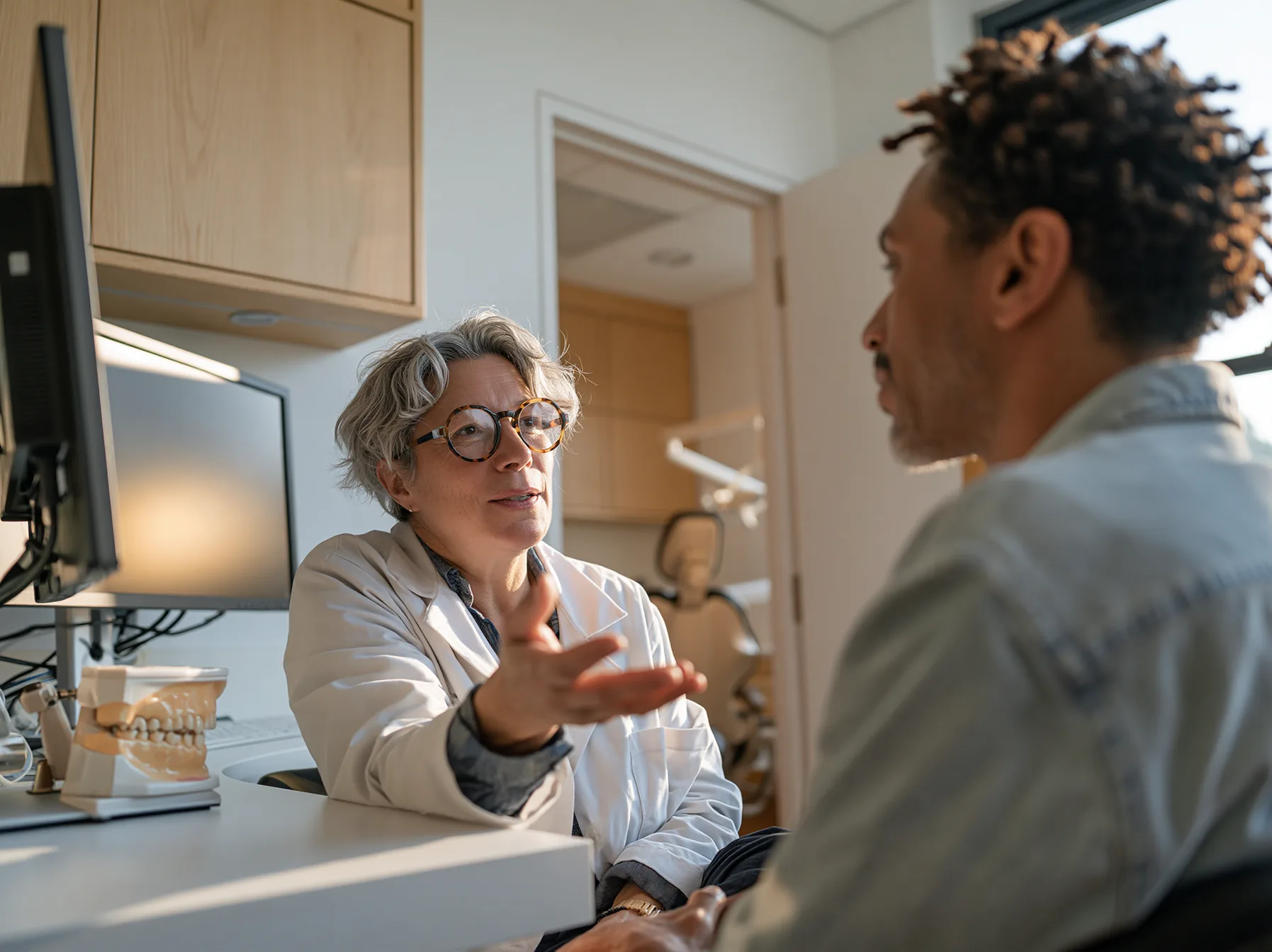 Dentist explaining the planned treatment to a patient during a consultation