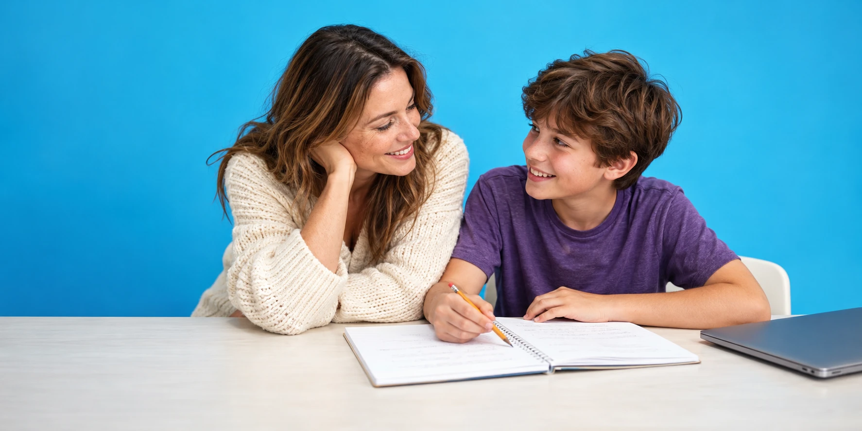 Parent and child reviewing a notebook together