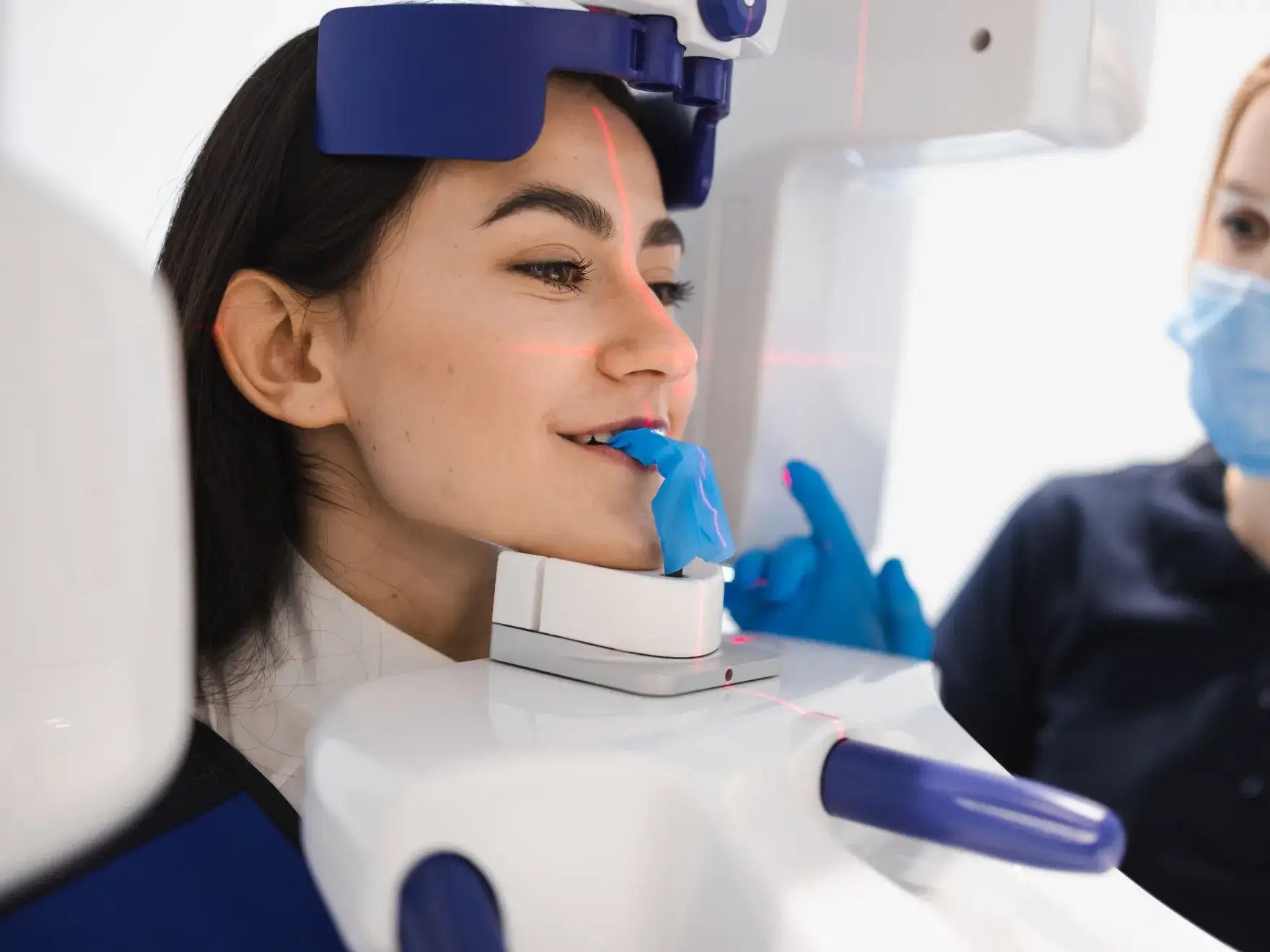 A woman getting her teeth checked by a dentist.