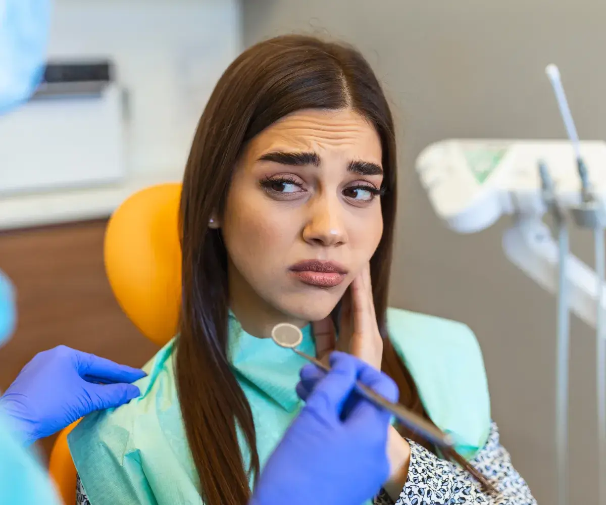 A woman getting her teeth checked by a dentist.