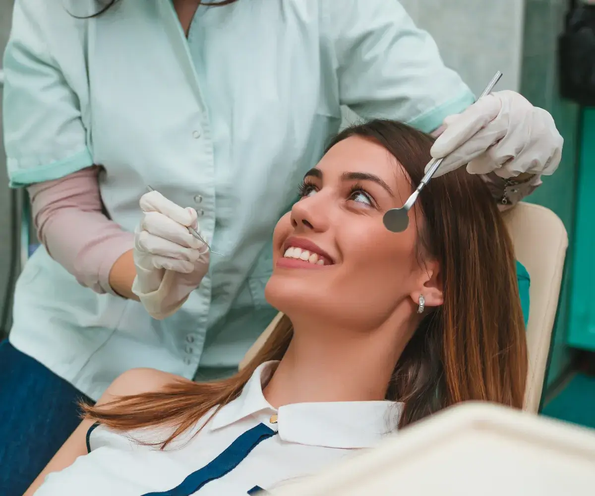 A woman getting her hair cut by a hair stylist.