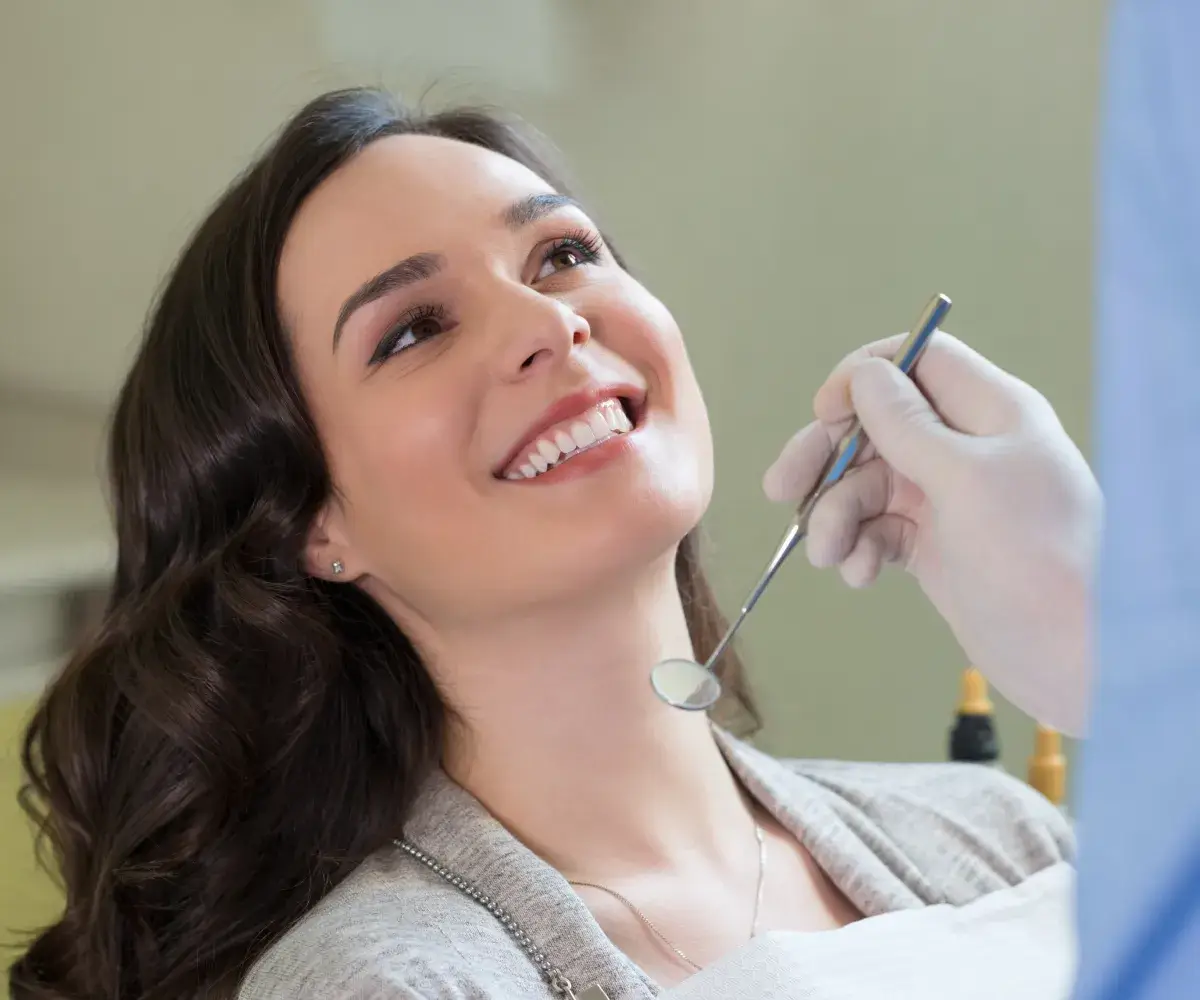 A woman getting her teeth checked by a dentist.