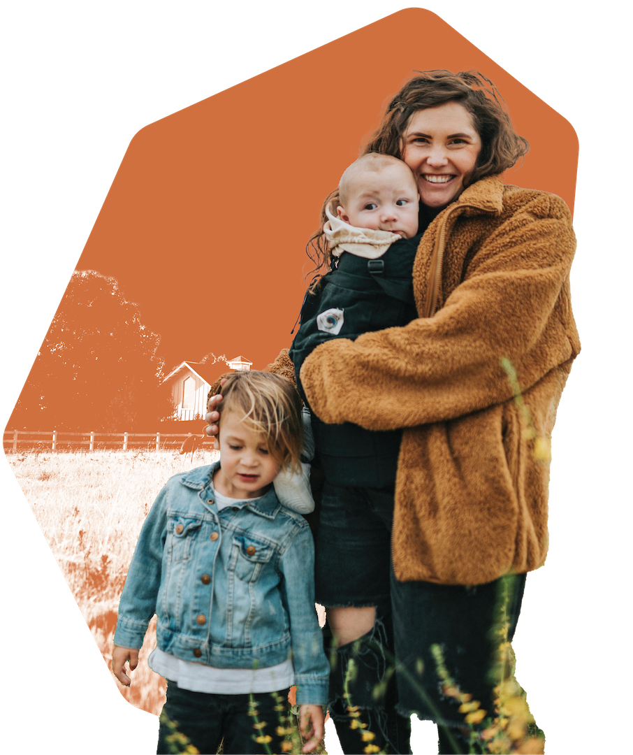 mom with two kids on a wheat field with a orange coloured background 
